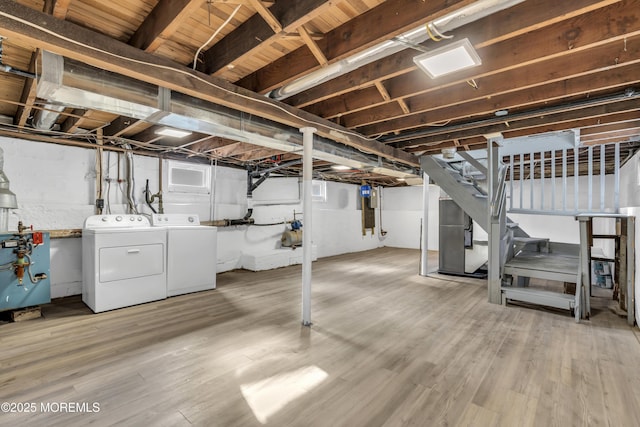 basement featuring hardwood / wood-style flooring and washing machine and clothes dryer