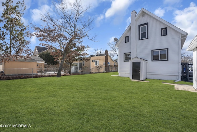 back of house with a lawn