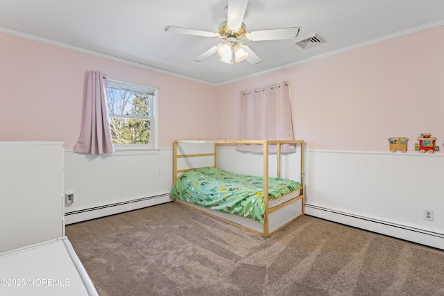 carpeted bedroom with ceiling fan, ornamental molding, and a baseboard heating unit