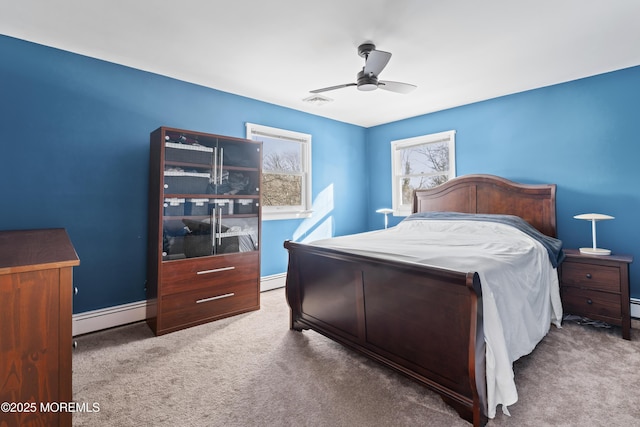 carpeted bedroom featuring ceiling fan and a baseboard radiator