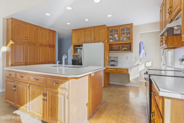 kitchen featuring decorative backsplash, a kitchen island with sink, appliances with stainless steel finishes, light tile patterned flooring, and sink