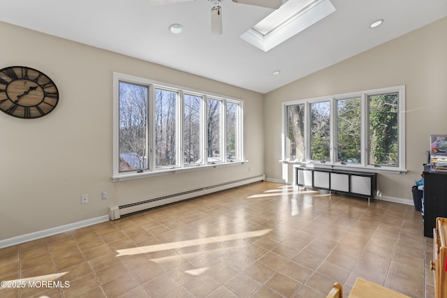 interior space featuring lofted ceiling with skylight, light tile patterned flooring, a baseboard heating unit, and ceiling fan