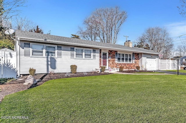 single story home featuring a garage, a front lawn, a chimney, and brick siding