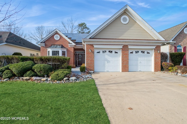 view of front of house featuring a garage, solar panels, and a front yard