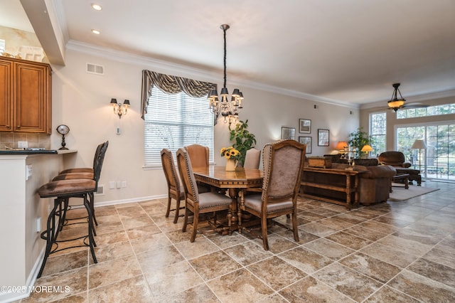 dining space with ceiling fan with notable chandelier and ornamental molding