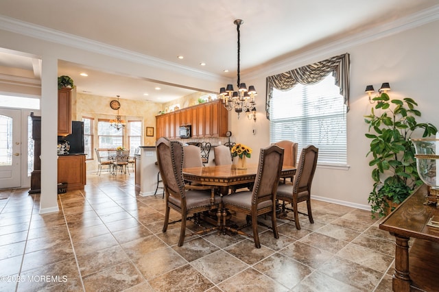 dining space featuring a notable chandelier and crown molding