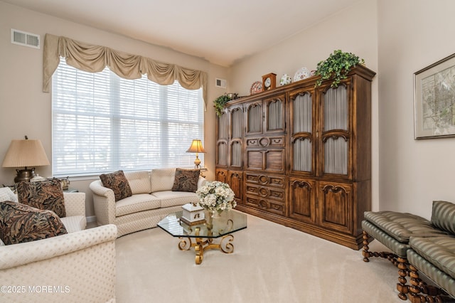 living room with a wealth of natural light and carpet flooring