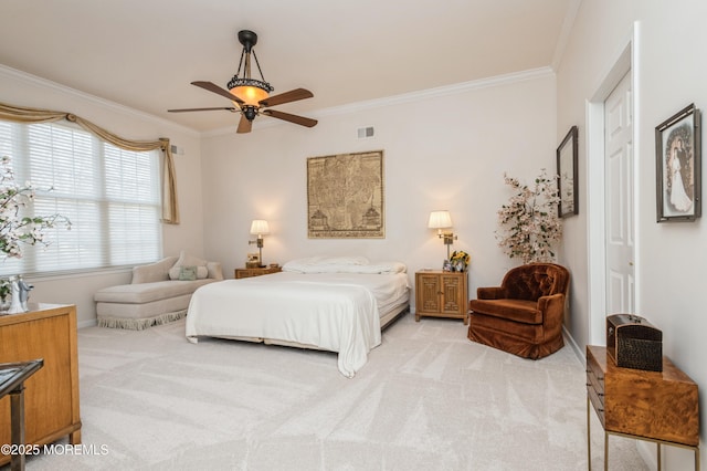 bedroom featuring ceiling fan, crown molding, a closet, and light carpet