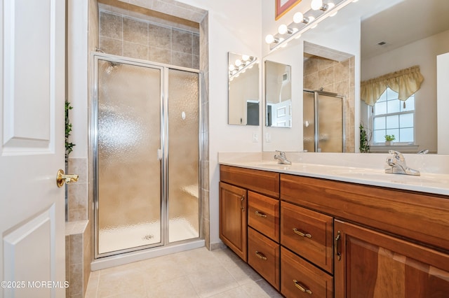 bathroom with tile patterned floors, an enclosed shower, and vanity