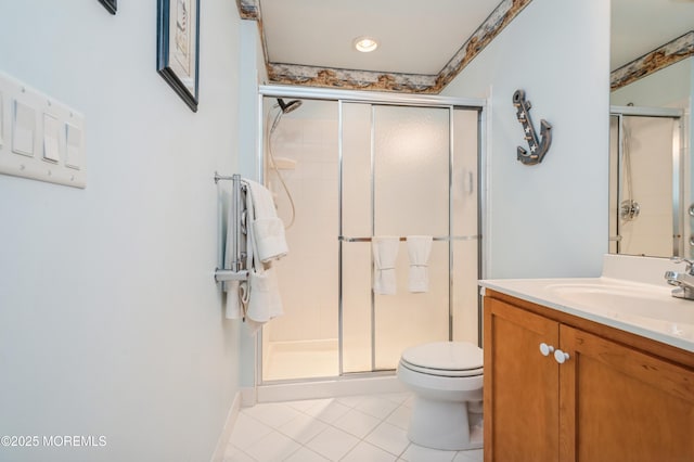 bathroom with toilet, tile patterned flooring, a shower with door, and vanity