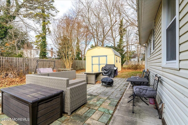 view of patio featuring area for grilling and a storage unit