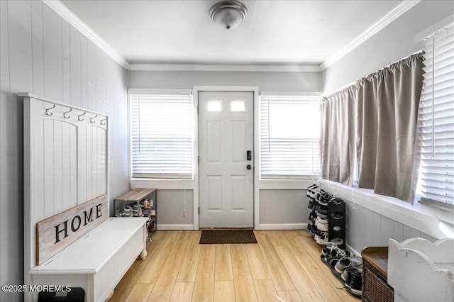 mudroom featuring light wood-type flooring, crown molding, and a healthy amount of sunlight