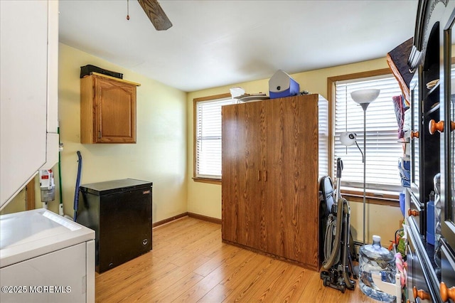 interior space with ceiling fan, light hardwood / wood-style flooring, refrigerator, and washer / dryer