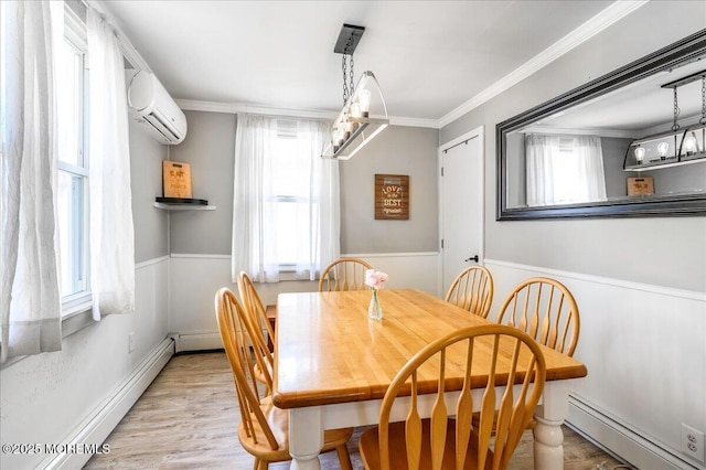 dining area featuring a wall mounted air conditioner, light hardwood / wood-style floors, baseboard heating, and crown molding