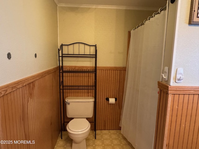 bathroom featuring toilet and ornamental molding