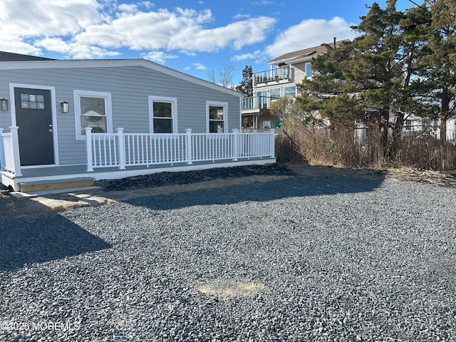 rear view of property featuring a deck