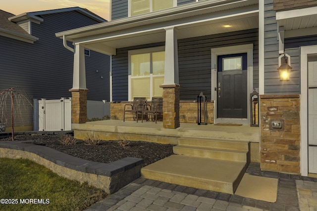 exterior entry at dusk with covered porch