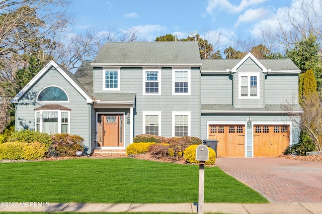 view of front facade featuring a garage and a front lawn