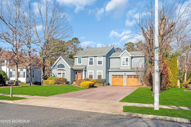 view of front of house featuring a garage and a front lawn