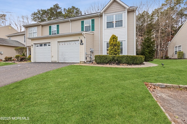 view of front of property with a front yard and a garage