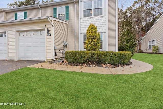 view of front property with a front yard and a garage