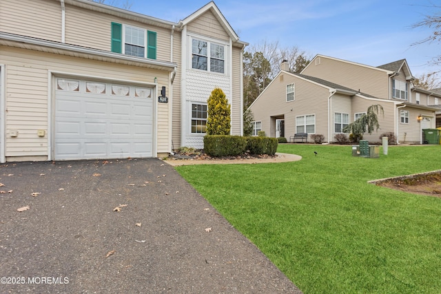 view of front of home with a front lawn and a garage