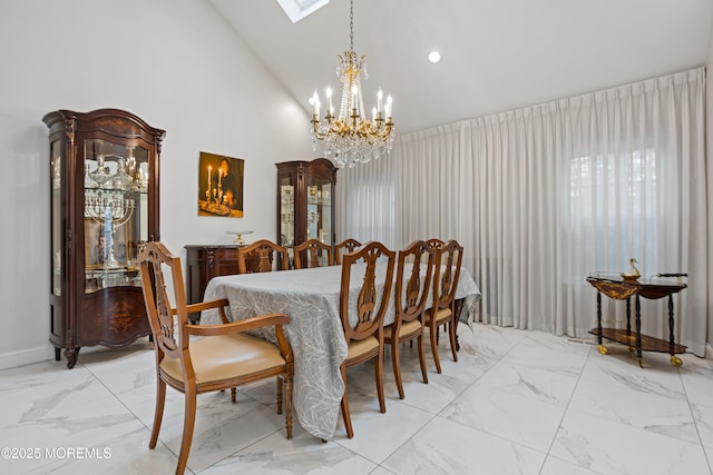 dining room with high vaulted ceiling and a notable chandelier