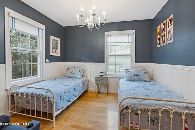 bedroom featuring a chandelier and wood-type flooring