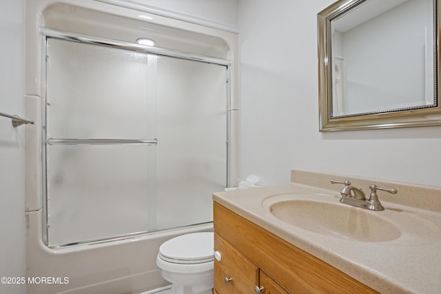 full bathroom featuring shower / bath combination with glass door, vanity, and toilet