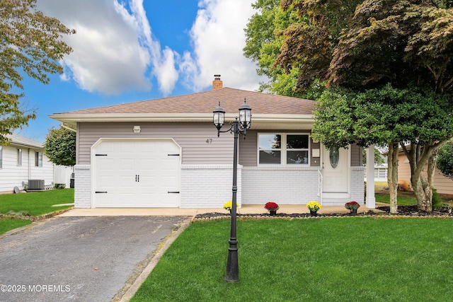 ranch-style house featuring central AC, a garage, and a front lawn