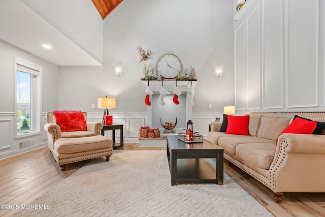 living room with lofted ceiling and light hardwood / wood-style flooring