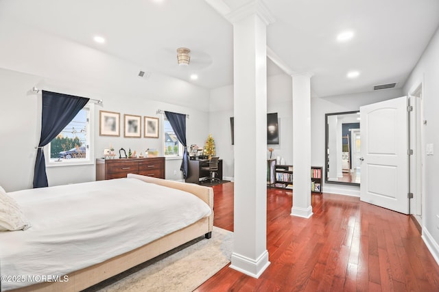 bedroom with wood-type flooring and ornate columns