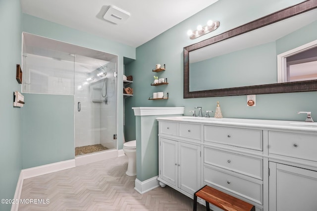 bathroom with vanity, toilet, a shower with door, and parquet flooring