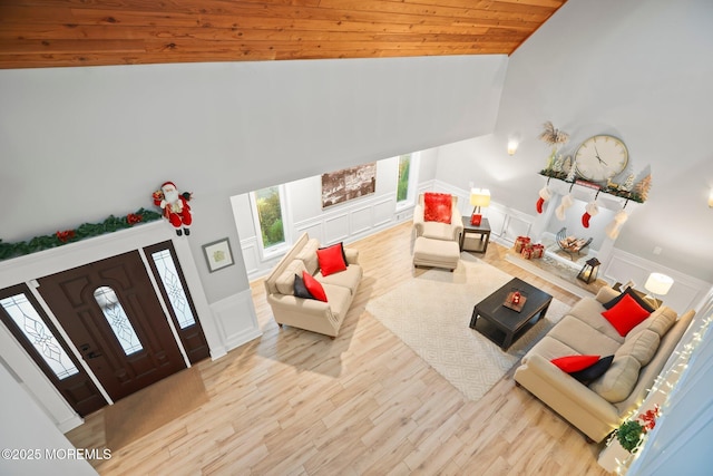 living room featuring wood ceiling, high vaulted ceiling, and light hardwood / wood-style flooring