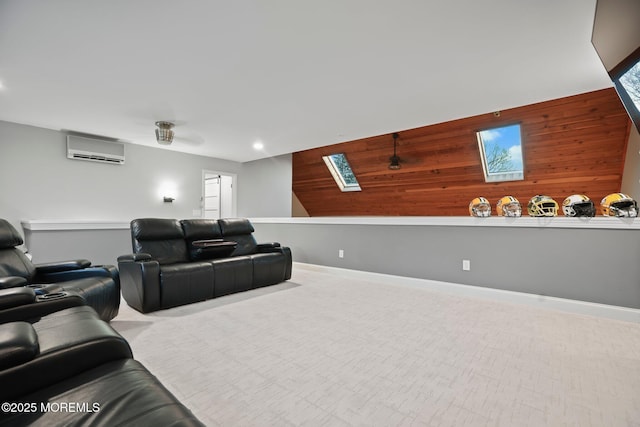 cinema with light colored carpet, an AC wall unit, and wood walls