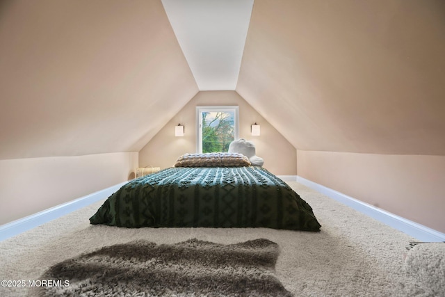 bedroom featuring carpet flooring and vaulted ceiling