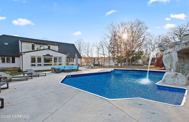 view of pool with an outdoor hangout area, pool water feature, and a patio area