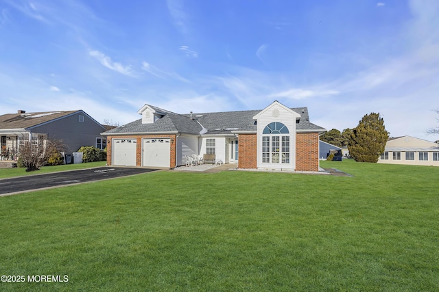 view of front of house featuring a garage and a front lawn