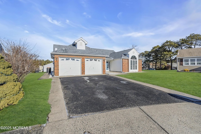 view of front of property with a garage and a front yard