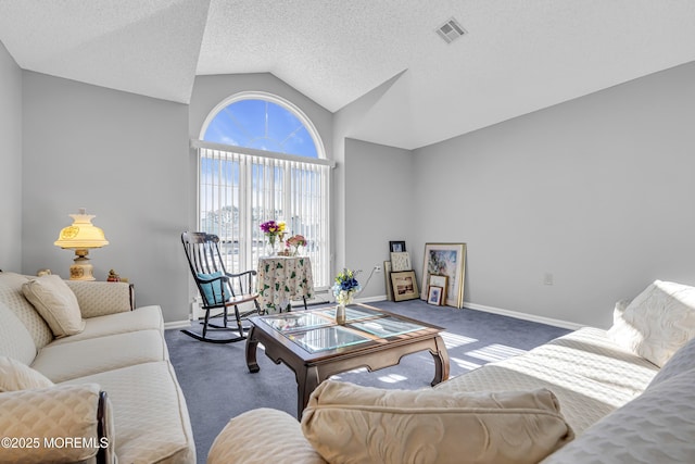 carpeted living room featuring a textured ceiling and vaulted ceiling