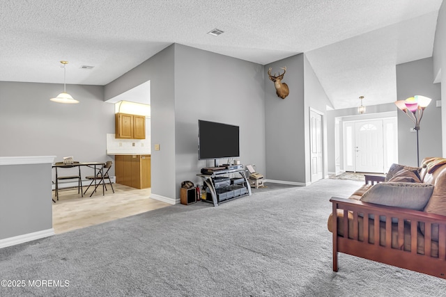 carpeted living room featuring lofted ceiling and a textured ceiling