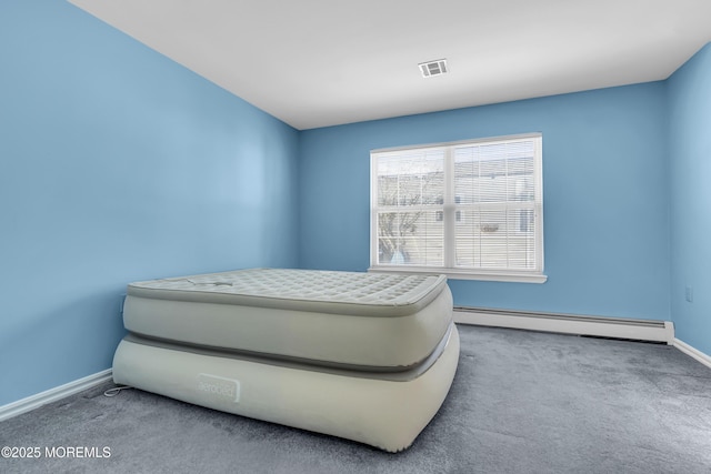 carpeted bedroom featuring a baseboard radiator