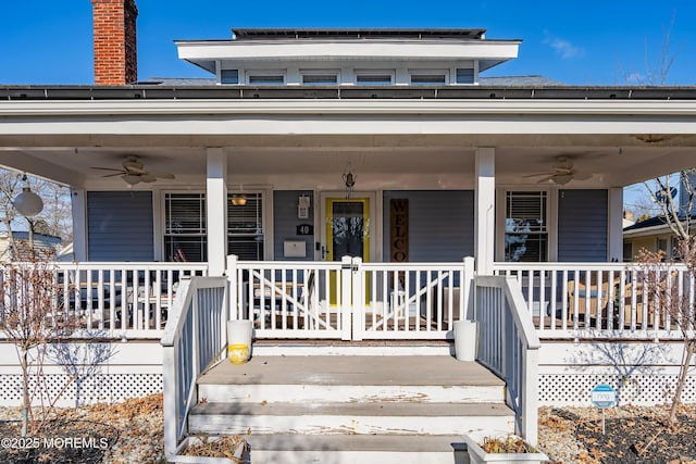 view of exterior entry featuring ceiling fan and a porch