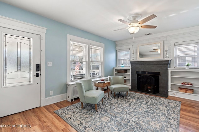 sitting room featuring ceiling fan and light hardwood / wood-style flooring