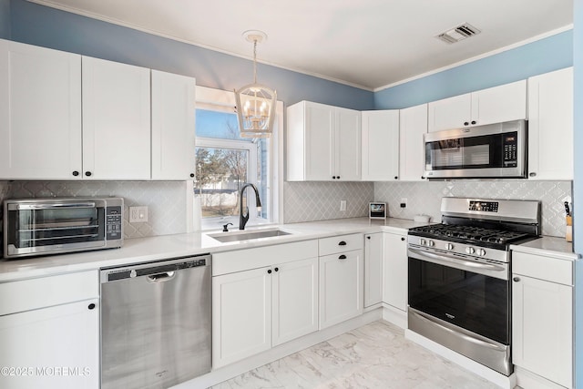 kitchen featuring white cabinets, appliances with stainless steel finishes, and sink