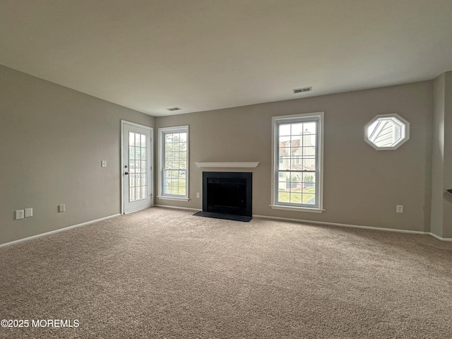 unfurnished living room with light colored carpet