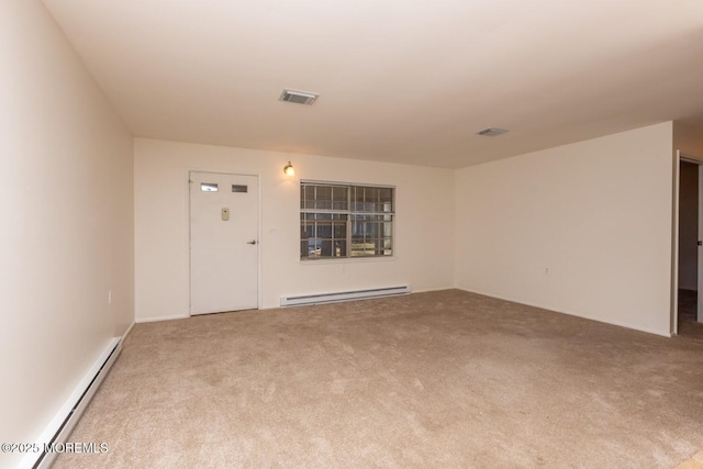 carpeted empty room featuring a baseboard radiator