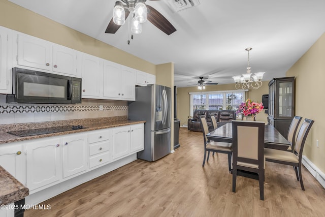 kitchen with pendant lighting, backsplash, black appliances, and white cabinets