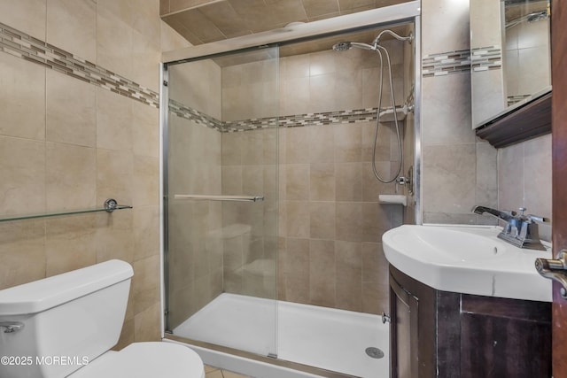 bathroom featuring vanity, tile walls, an enclosed shower, and toilet