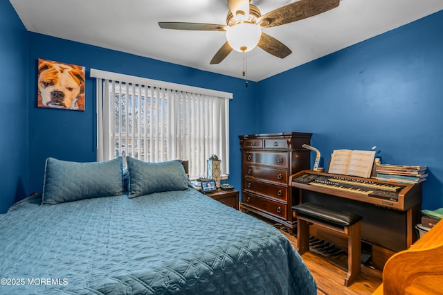 bedroom with hardwood / wood-style floors and ceiling fan